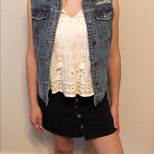 Distressed denim vest.
